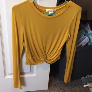 A yellow long sleeve crop top